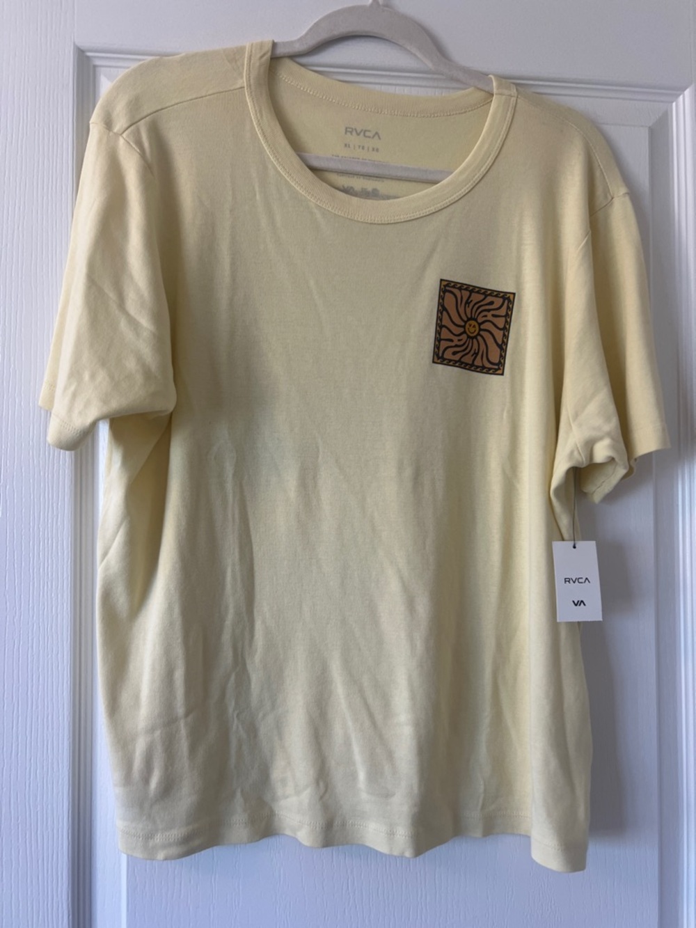 NWT. RVCA Pale Yellow Short Sleeve Tee with Brown Sun Patch SIZE CL